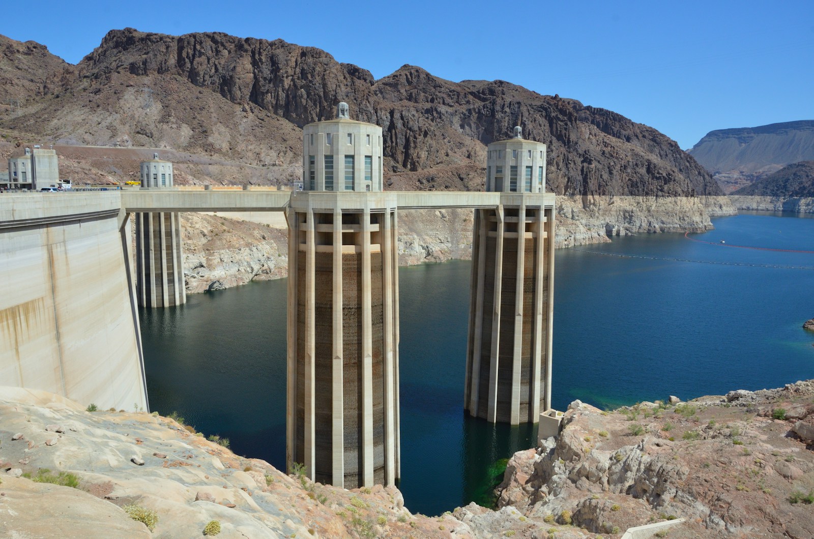 The curved concrete wall of Hoover Dam between canyon walls