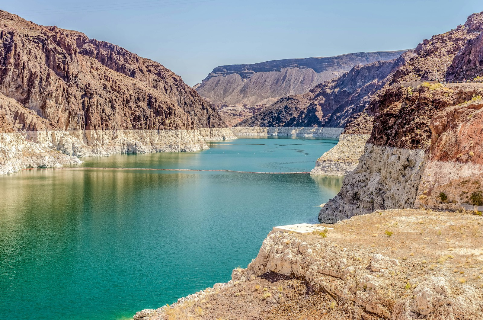 A road running above the blue water of Lake Mead
