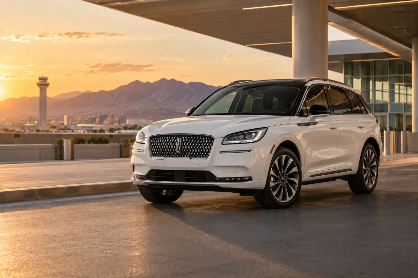 White 2026–2027 Lincoln Corsair Luxury SUV at an airport terminal at sunset with the control tower, city skyline and mountains behind